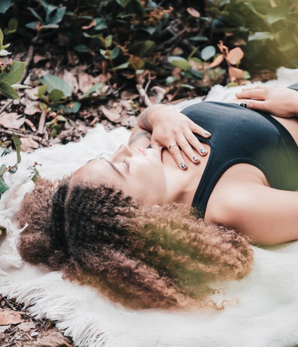 reconnect with nature woman lying on the ground meditating