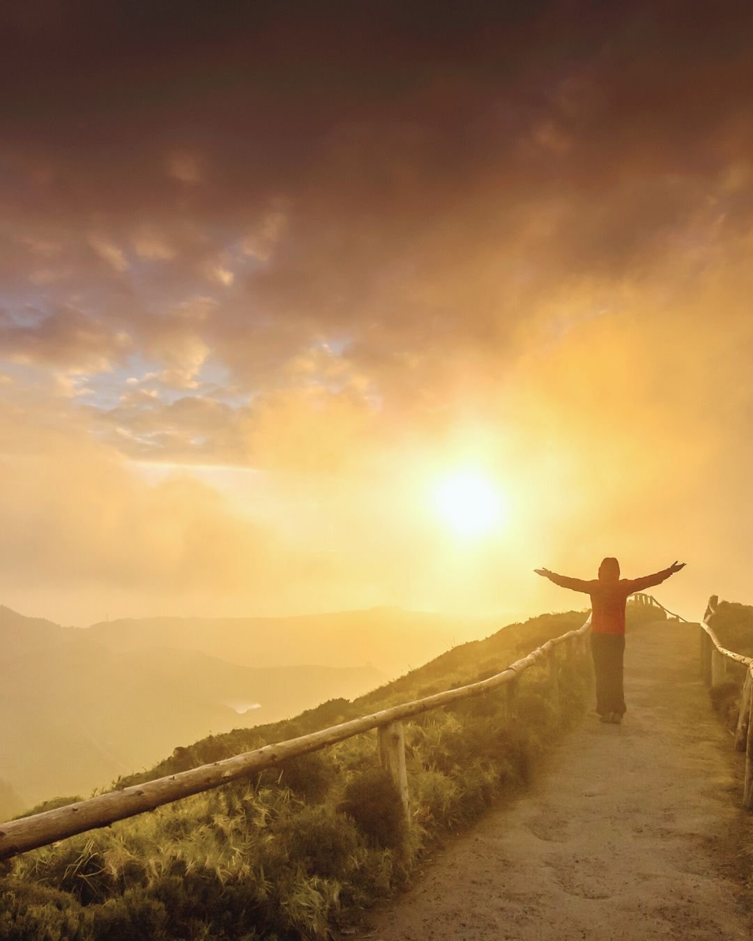 person with arms open to the sun
