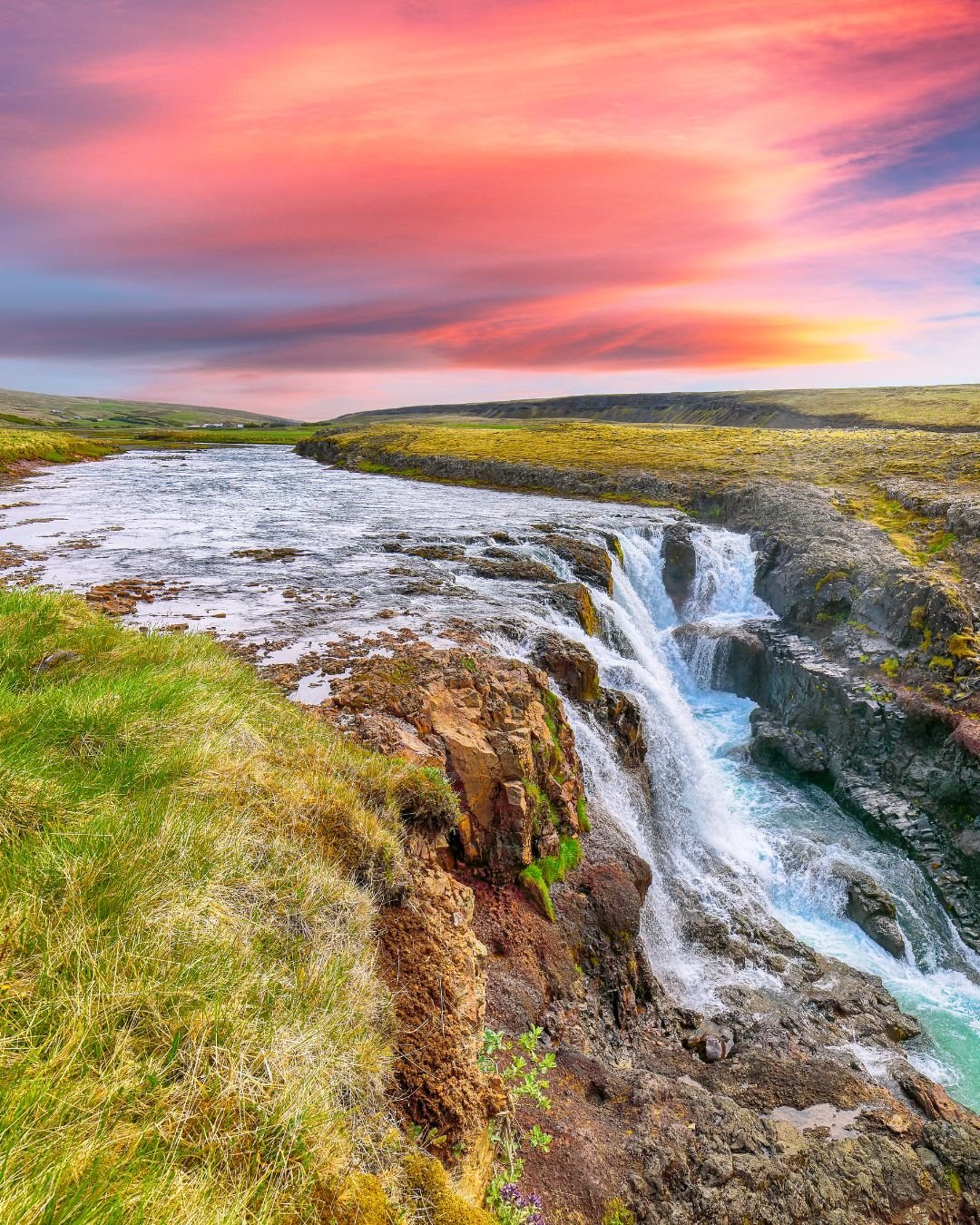 red sky over waterfall