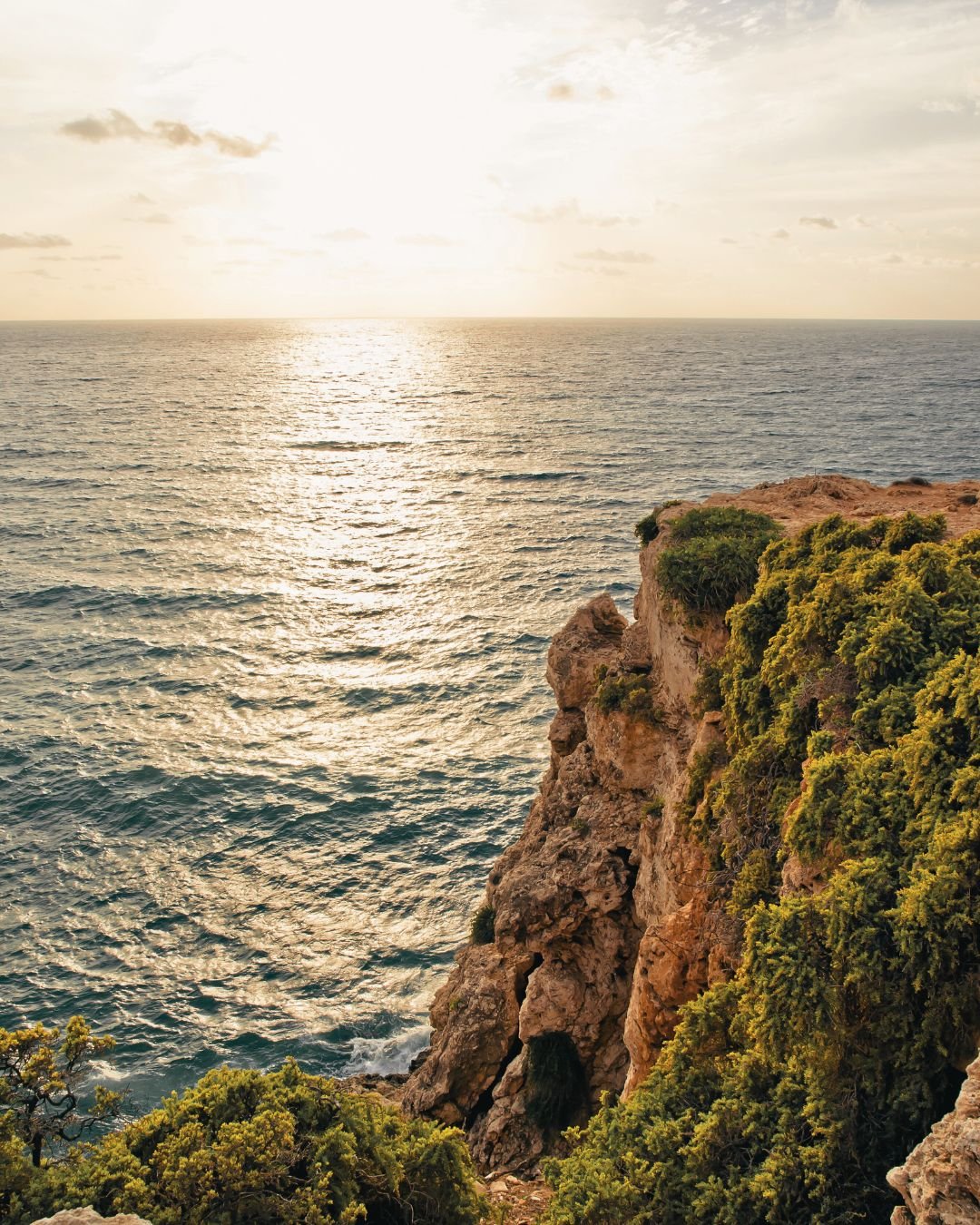 sun on sea with cliff