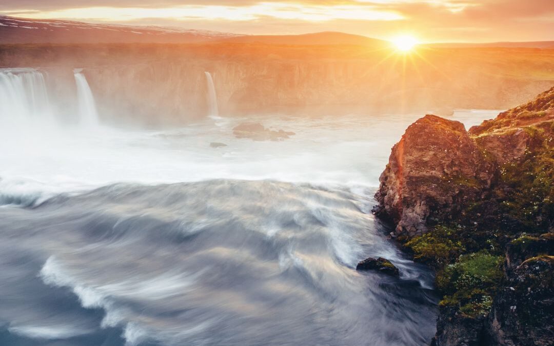 sun over waterfalls