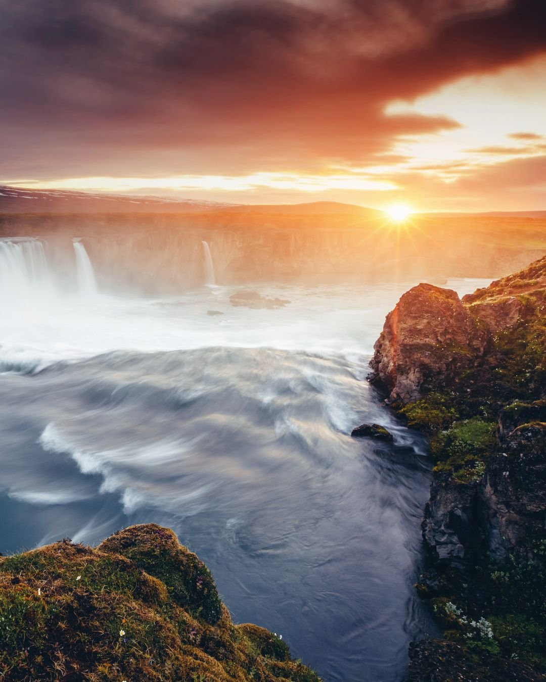 sun over waterfalls