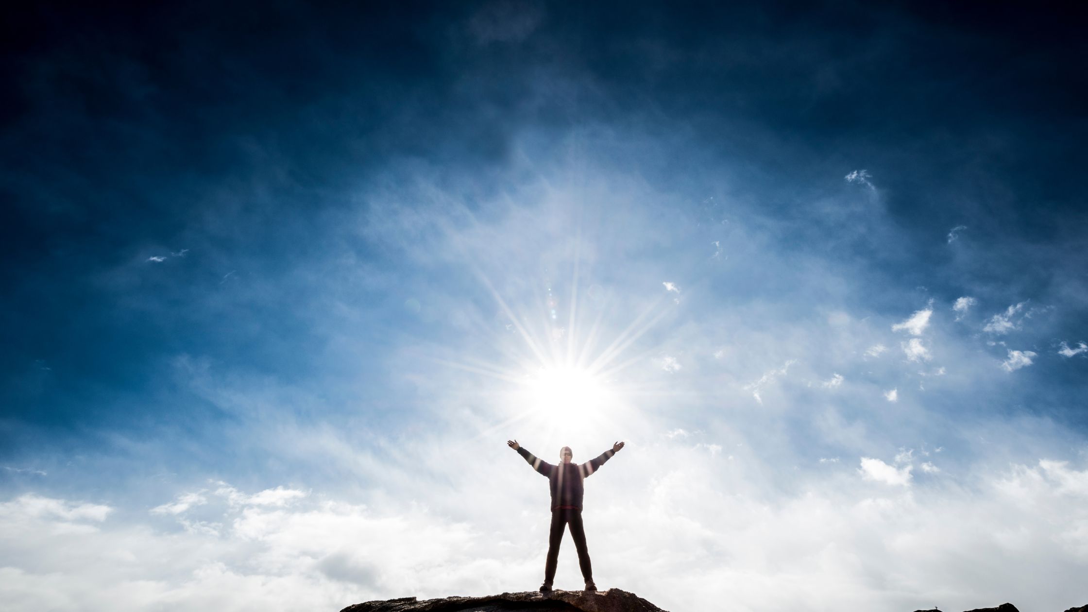 Person on the top of the mountain