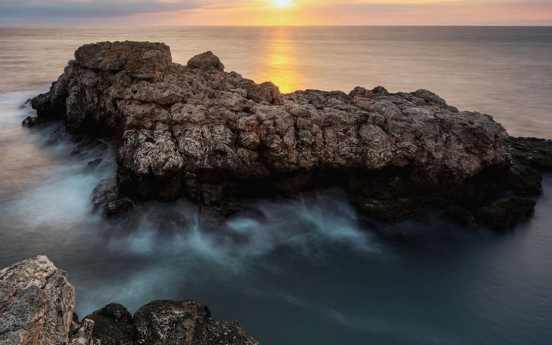 sunrise over ocean and rocks