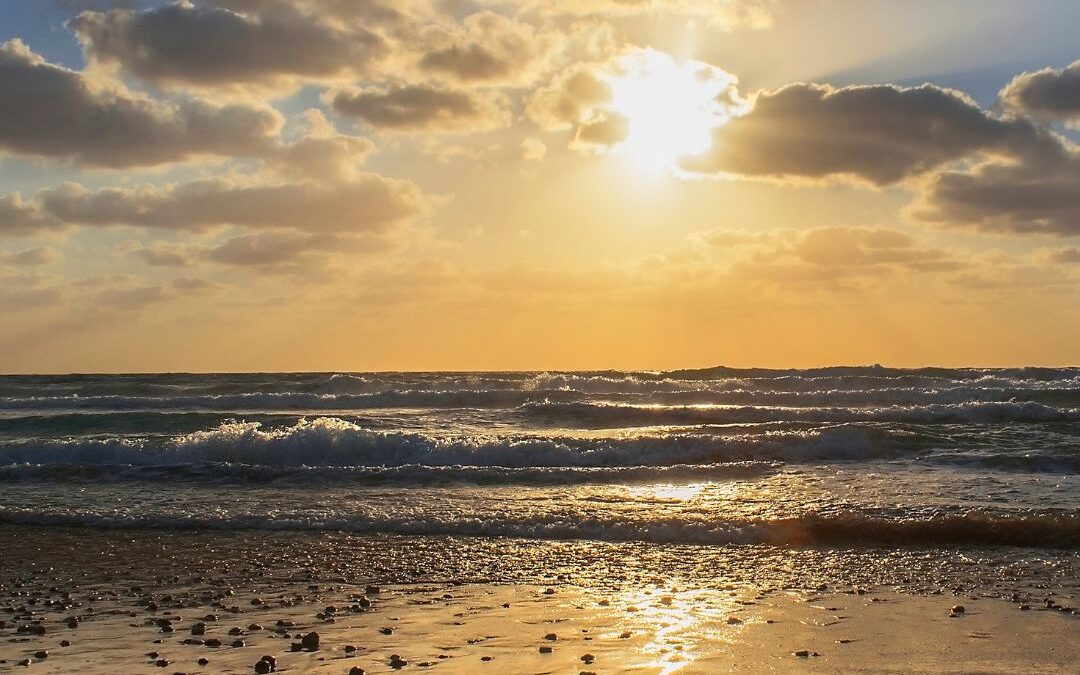 sun over ocean beach