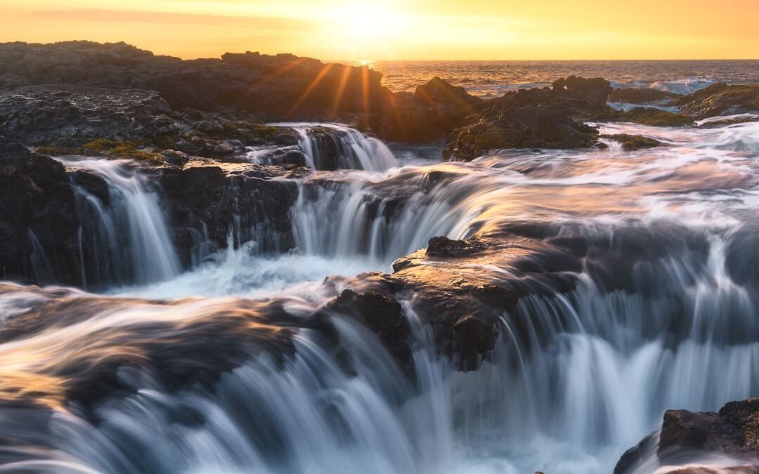 Sunrise over ocean rocks