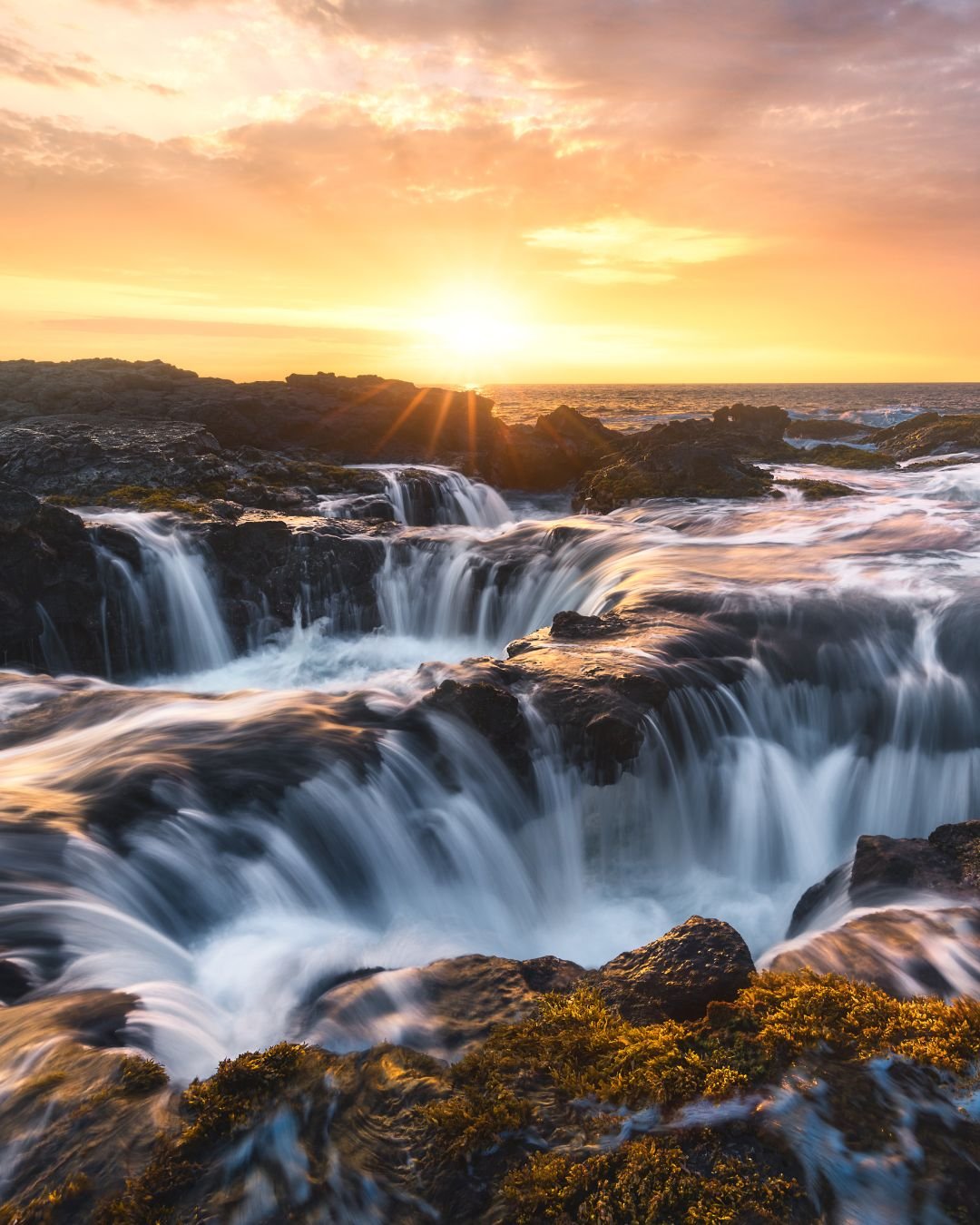 Sunrise over ocean rocks