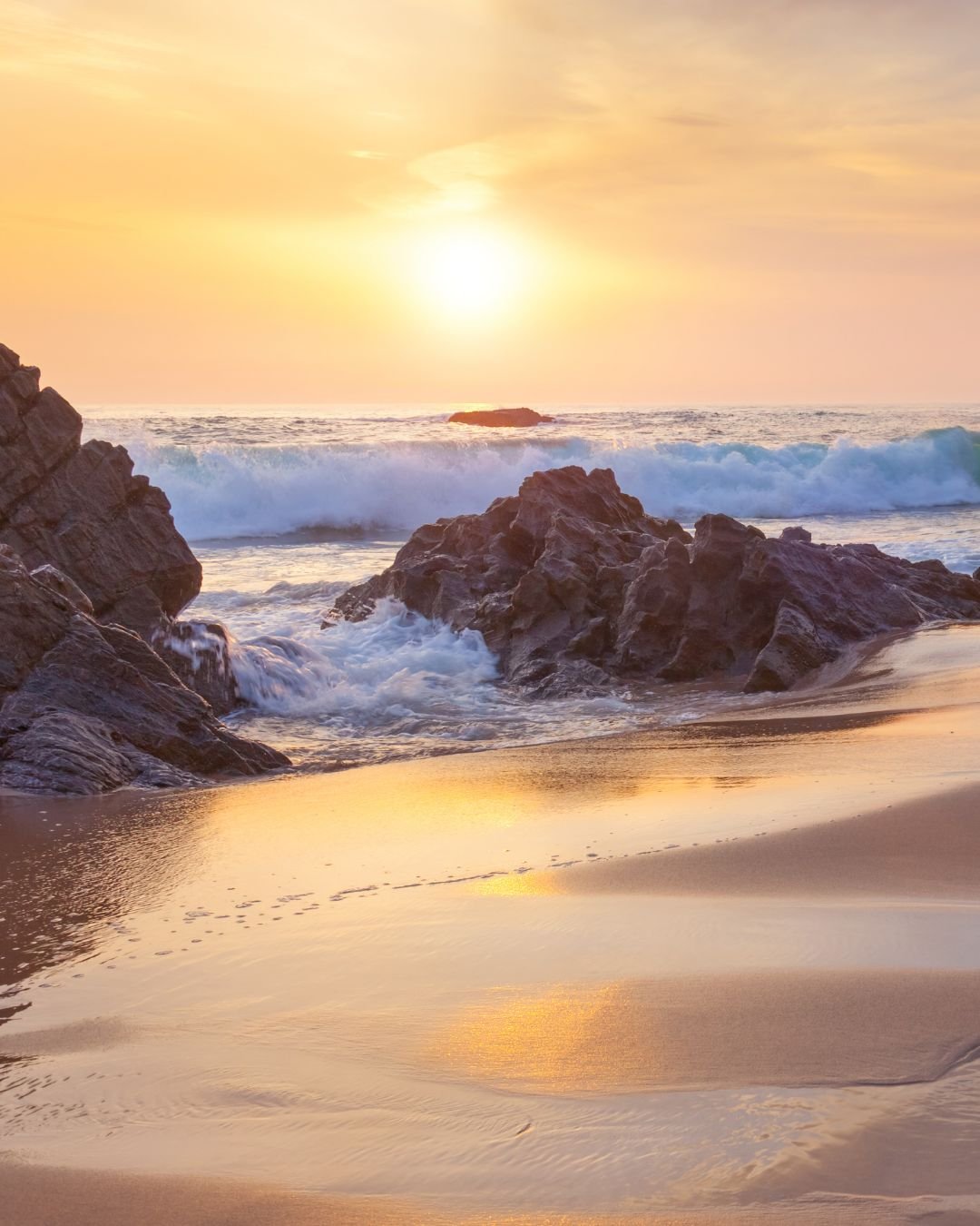 sun over beach rocks