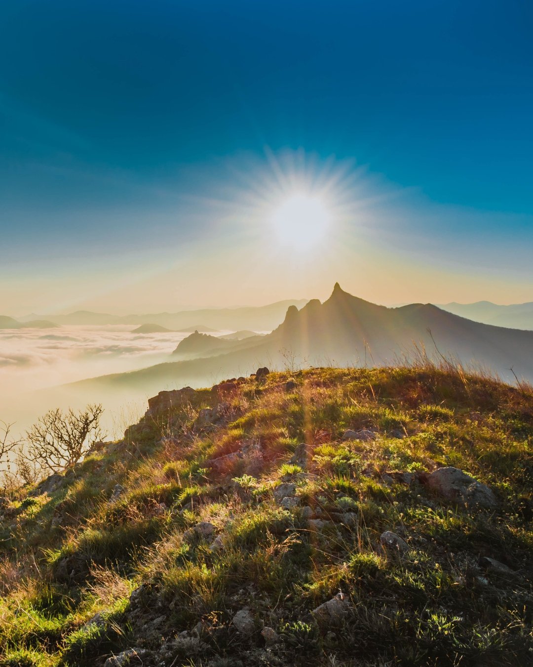 sun over mountain peak
