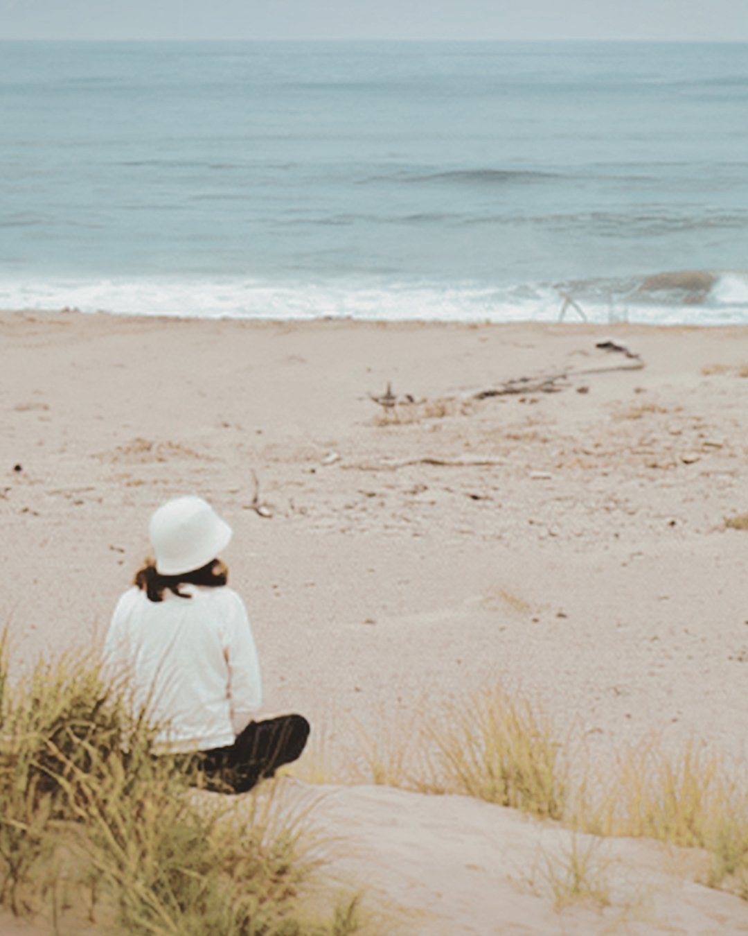 woman sitting on the beach